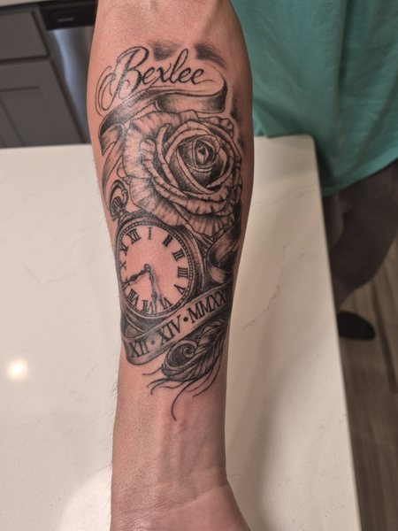 Rose and lettering tattoo