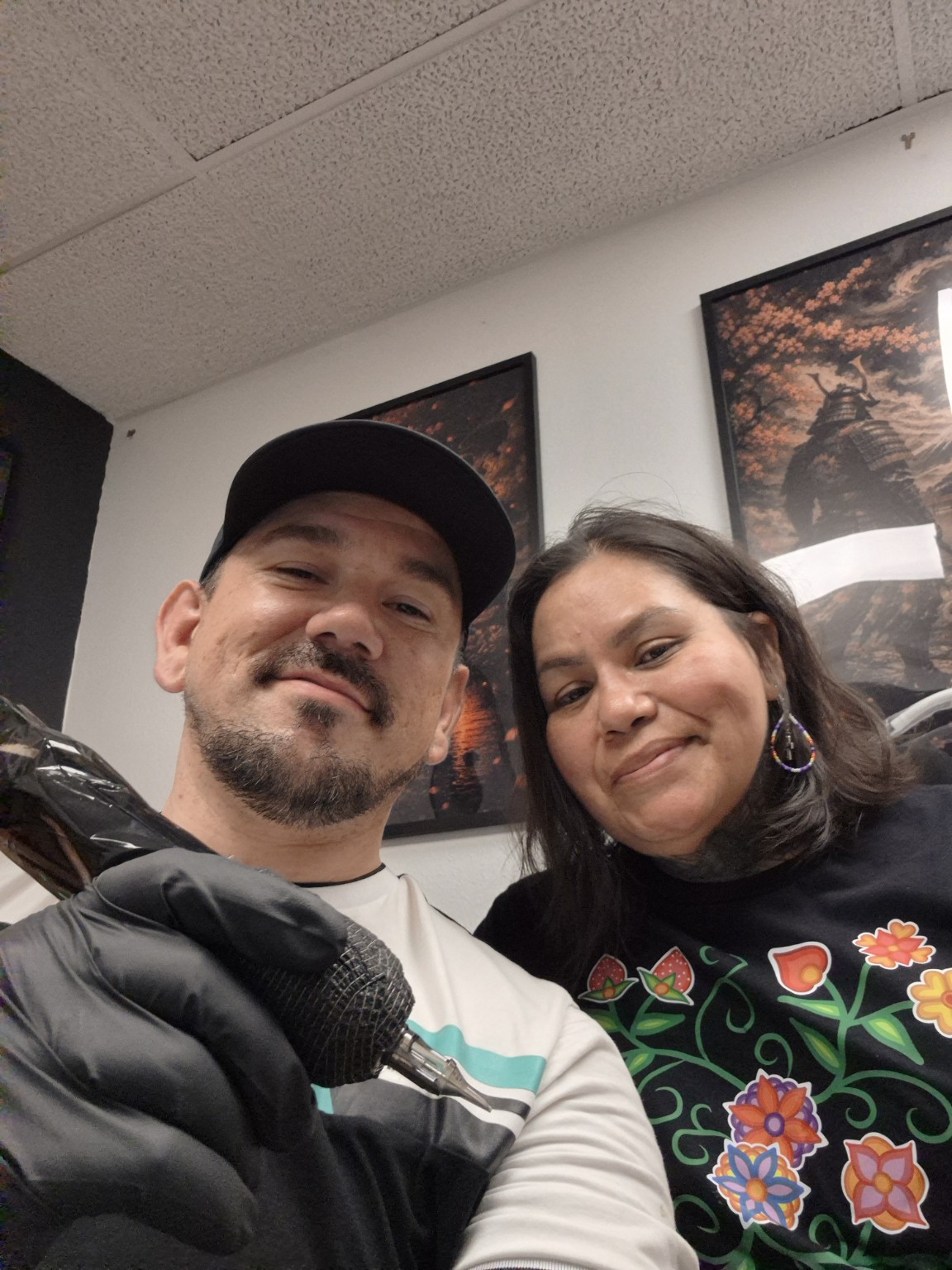 Jordan Parisien with a guest at Convicted Ink Studios